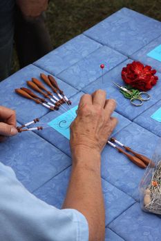 Process of lace-making with bobbins 