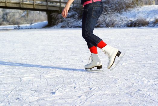 Anonymous legs ice skating on natural ice.         