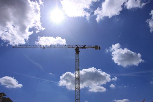 Construction crane against the blue sky 