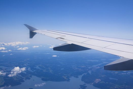 A view of wing and clouds from an airplane window