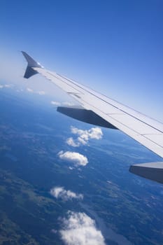 A view of wing and clouds from an airplane window