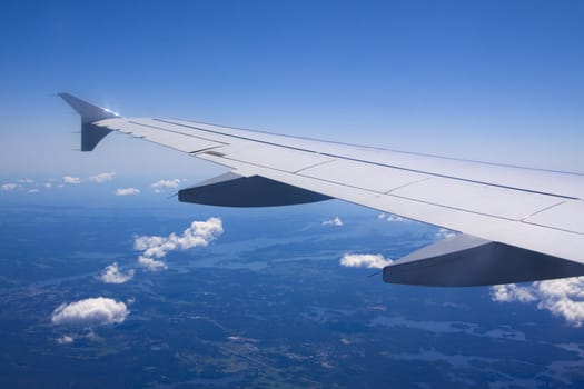 A view of wing and clouds from an airplane window