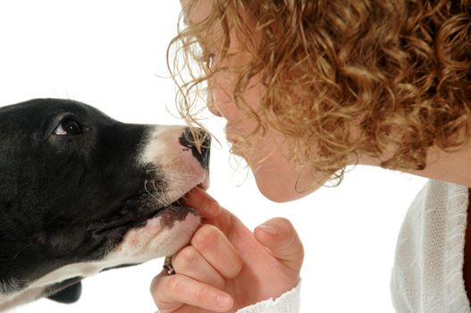 Young woman and sweet puppy close together.