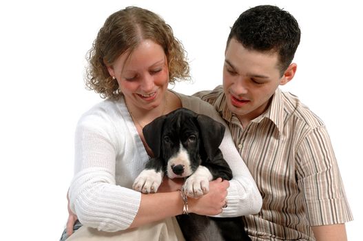 Young happy couple and sweet puppy