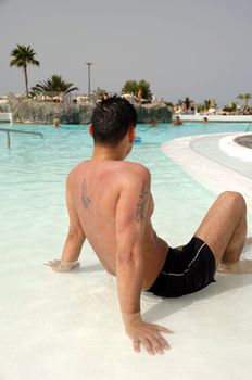 A man is relaxing in swimming pool