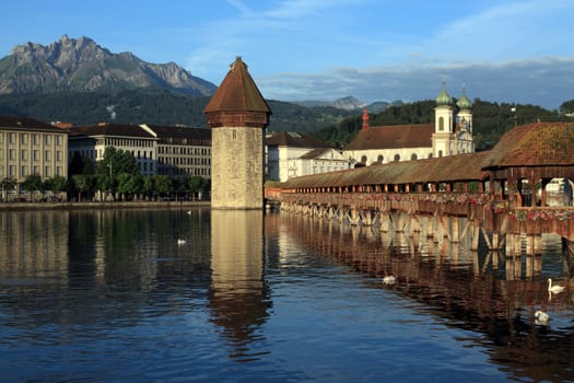 The Chapel Bridge and Lake Lucerne, in the city of Lucerne, Switzerland.  Photo taken early in the morning as the sun starts to rise.