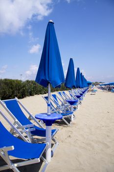 Closed beach umbrellas in Terracina Italy