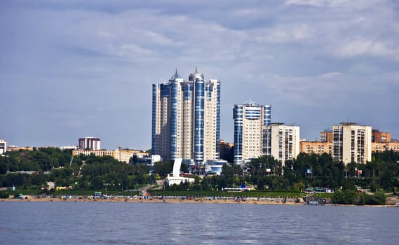 Sky with storm clouds over the port city. Samara, Russia. City Quay and beaches with residential skyscrapers.