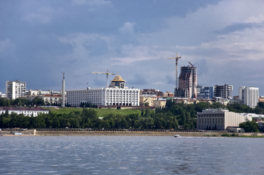 Sky with storm clouds over the port city. Samara, Russia. Construction cranes on the skyline