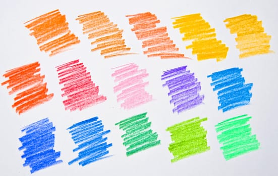 Multi colored pencil strokes on white paper. Isolation of a studio shot.