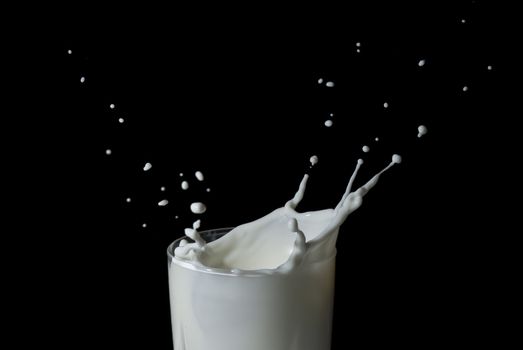 Abstract milk splash against black background