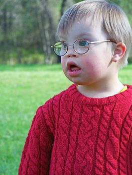 Downs Syndrome boy with mud on his face