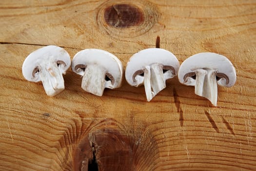 fresh champignon mushroom sliced on wooden background