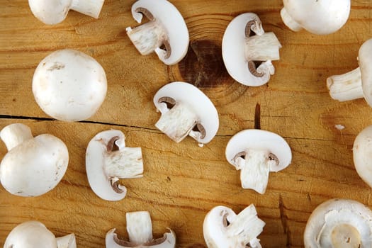 fresh champignon mushroom on wooden background