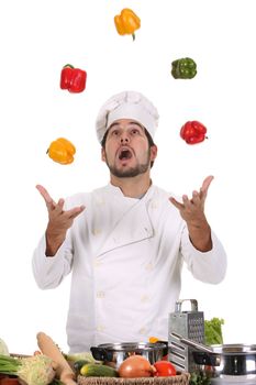 funny chef juggling with peppers in colors