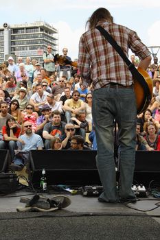 Barefoot guitarist out front at the Cascade Steps stage during the annual Bristol Harbour Festival attended by an estimated 250,000 people over 3 days in 2009