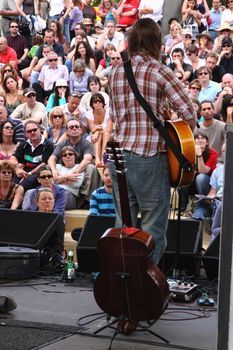 Guitarist playing to an attentive audience at the Cascade Steps stage during the annual Bristol Harbour Festival attended by an estimated 250,000 people over 3 days in 2009 