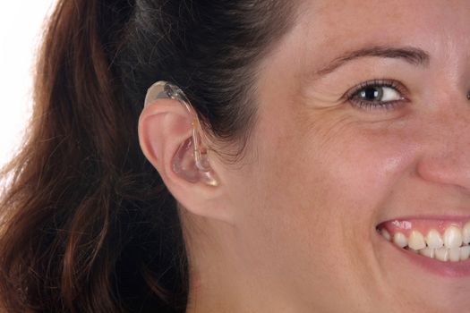 Beautiful young woman with hearing aid, closeup shot