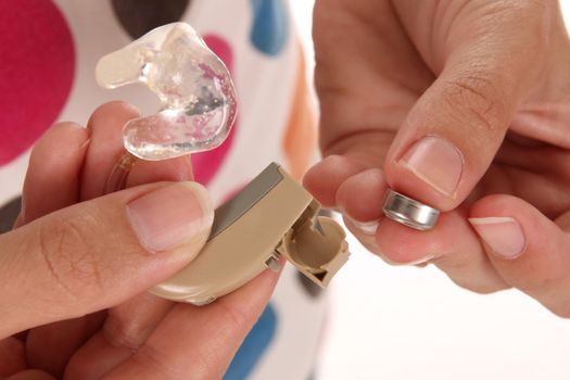 details hearing aid and battery in closeup