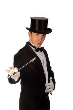 young magician performing with wand on white background