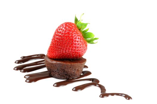 Chocolate brownie and strawberry with chocolate sauce.