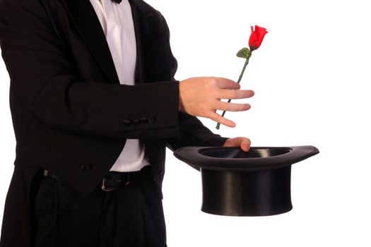 young magician performing with high hat  and red rose 