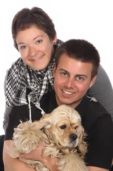 Girl, guy and american cocker spaniel over a white background