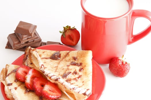 sweet meal with cup of milk and cakes and chocholate and strawberries