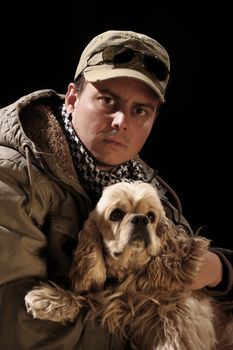 beauty fashion male and american cocker over a black background