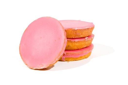 Pink glazed cookies stacked isolated on white