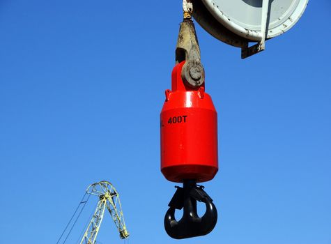 Hook of the powerful ship crane on a background of the blue sky