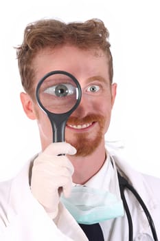 Portrait of smiling doctor with loupe on white background