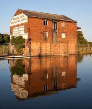 Ellesmere canal in Shropshire with old red brick warehouse