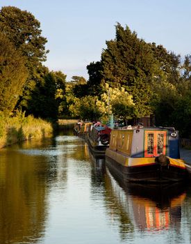 Row of canal barges on the river near Ellesmere in Shropshire