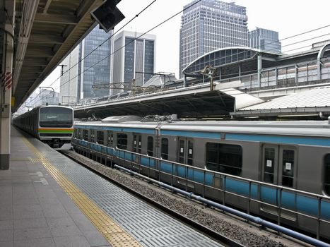 Railway station in central tokyo with trains on track