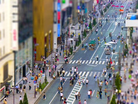 Tokyo crosswalk with crowd in pedestrian zone during summertime