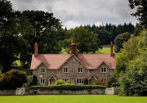 Two semi-detached cottages in the fields and hills of England