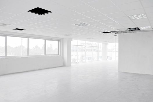  Empty bright interior white office under construction without furniture inside