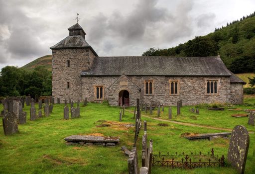 Threatening skies over the old stone church of Melangell