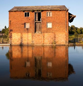 Ellesmere Canal in Shropshire, England with reflection of old warehouse