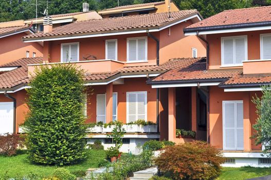 Italian orange townhouses style in daylight with garden