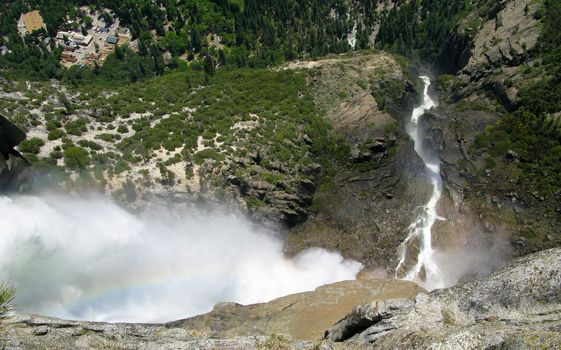 Vertical shot of the falling water down to the Yosemite Valley with rainbow