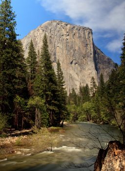 Yosemite view with slow shutter speed providing smoothed calm waters of rushing river
