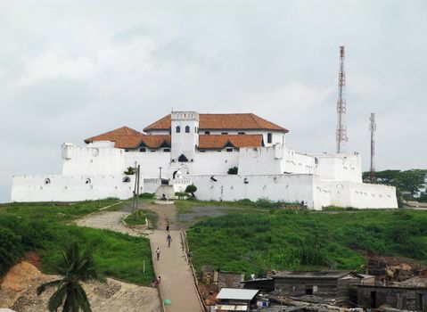 Entry to Elmina Fort near Accra in Ghana with shanty buildings in the foreground
