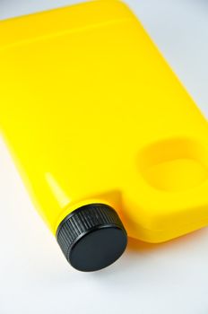 close up of a yellow container on white background