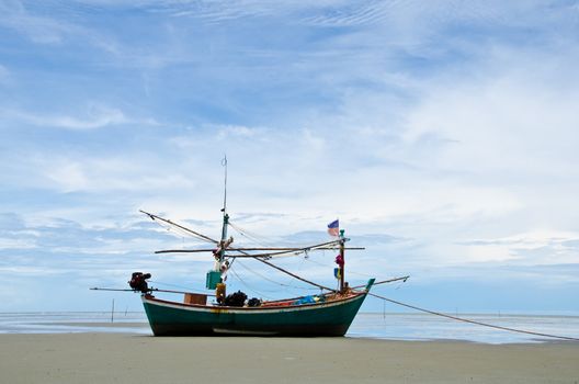 Coastal fishing boats anchor on the beach, Hua Hin, Thailand.