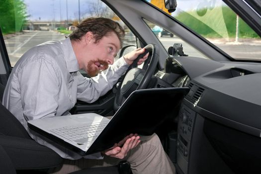 driver using GPS laptop computer in a car 