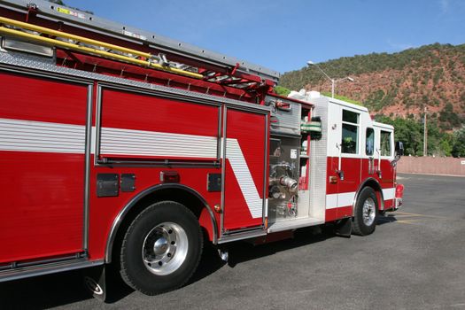Bright red fire engine used to respond to emergency in mountain town.