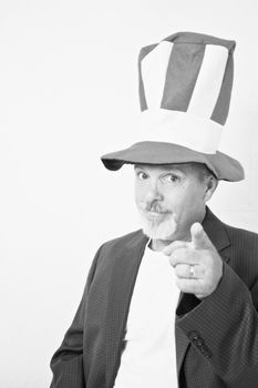 Middle aged man with tall top hat pointing finger at camera.