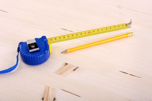 closeup shot of wooden plank and measuring tape 